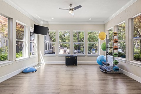 Large fitness room with yoga studio.