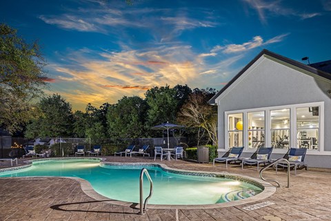 Resort style pool with lounge seating.