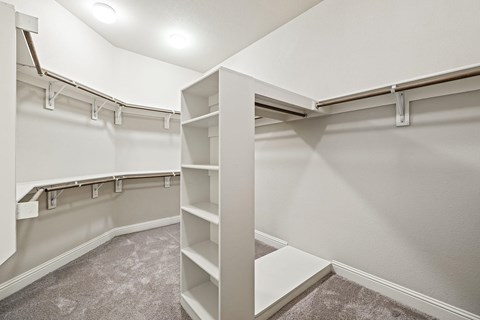 Large, spacious walk-in closet with built in organization.