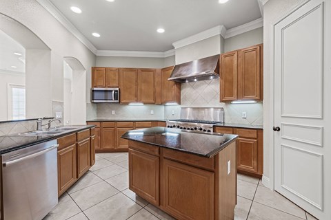 Gourmet kitchen with stainless steel stove top.