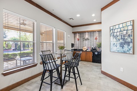 A dining room with a table and chairs.