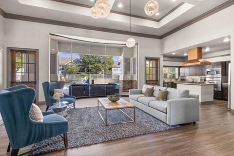 A modern living room with a blue chair and a grey sofa.