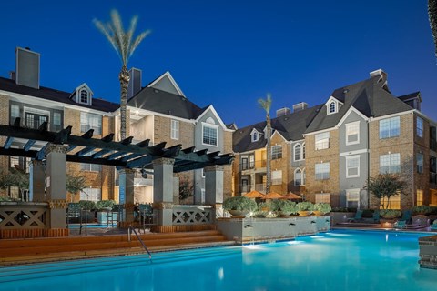 A swimming pool in front of apartment buildings.