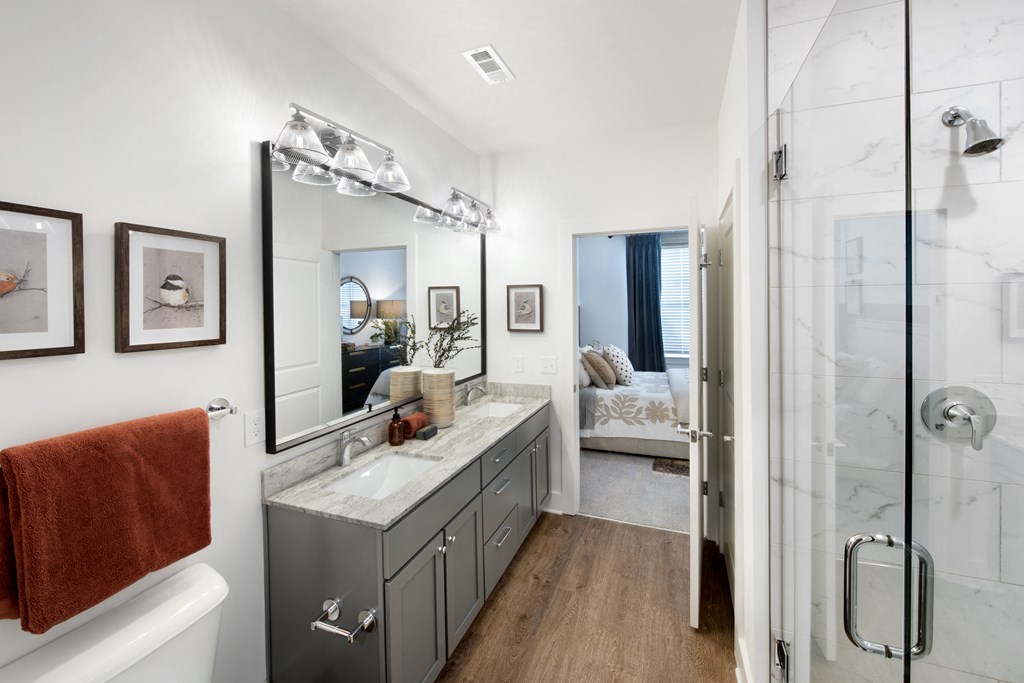 a bathroom with a shower and a sink and a mirror