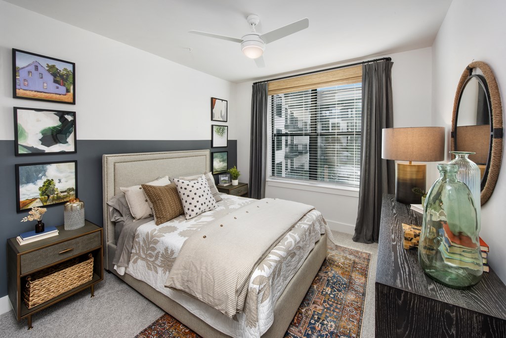 a bedroom with a bed and a large window