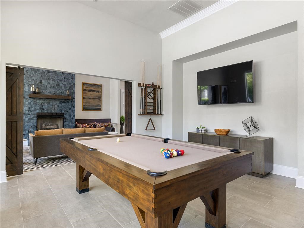 a pool table in a living room with a television