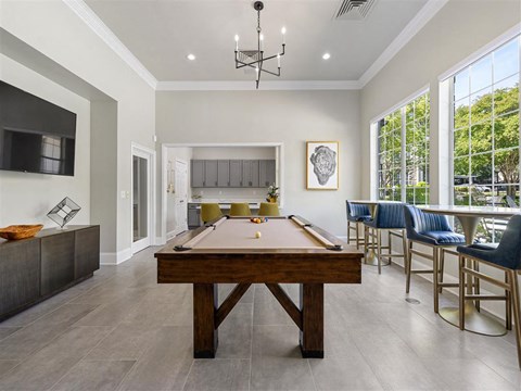 a pool table in the center of a living room