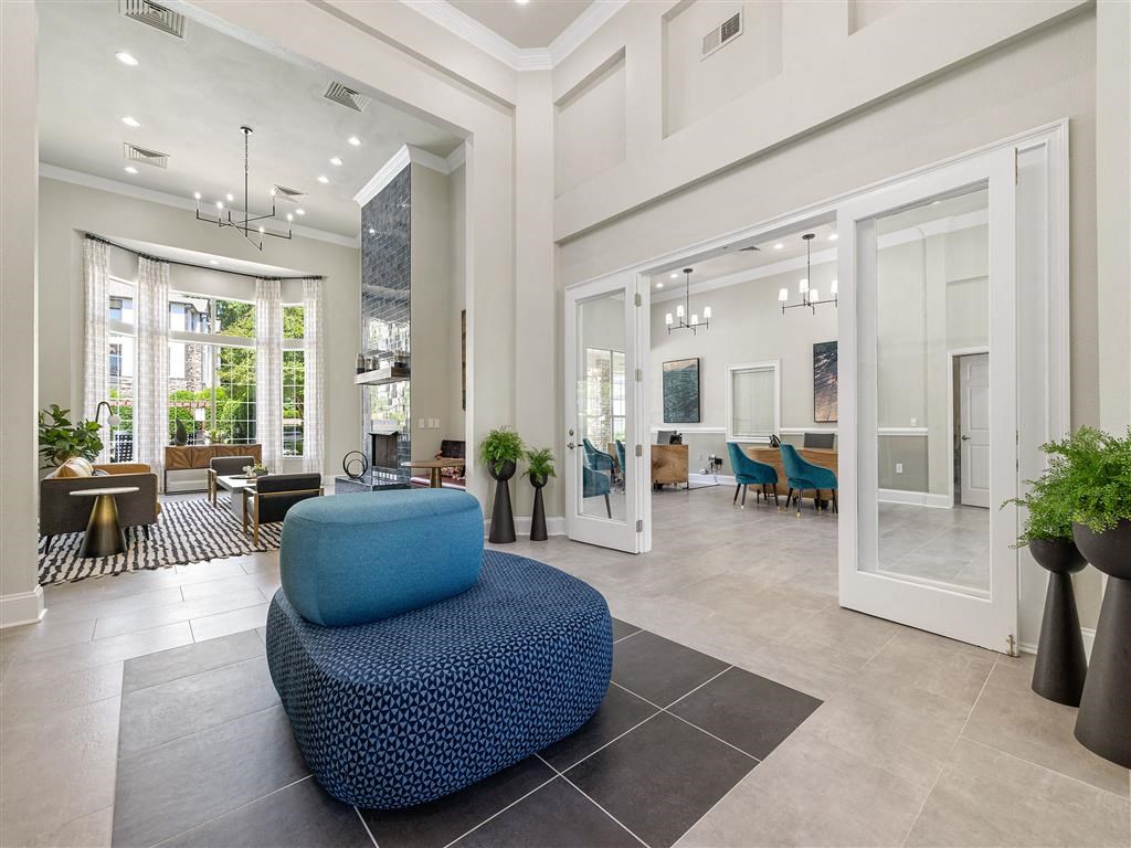 a living room with a blue couch in the middle