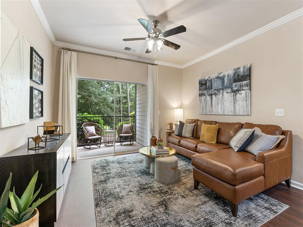 a living room with a couch and a ceiling fan