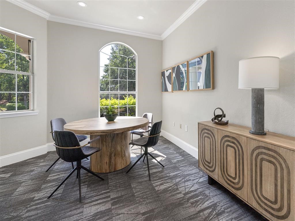 a dining room with a table and chairs and a lamp