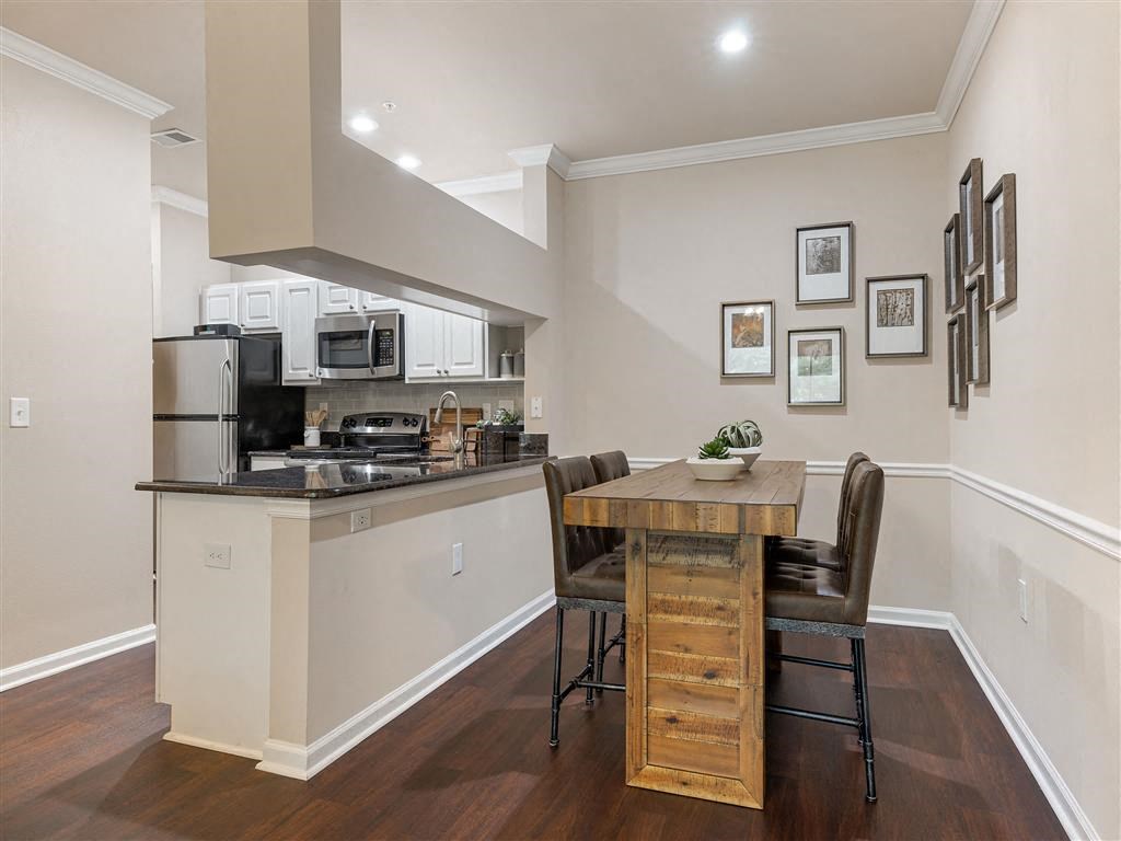 a kitchen and dining area with a table and chairs