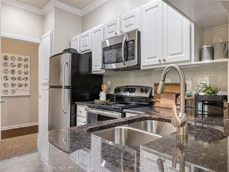 a kitchen with granite counter tops and a sink