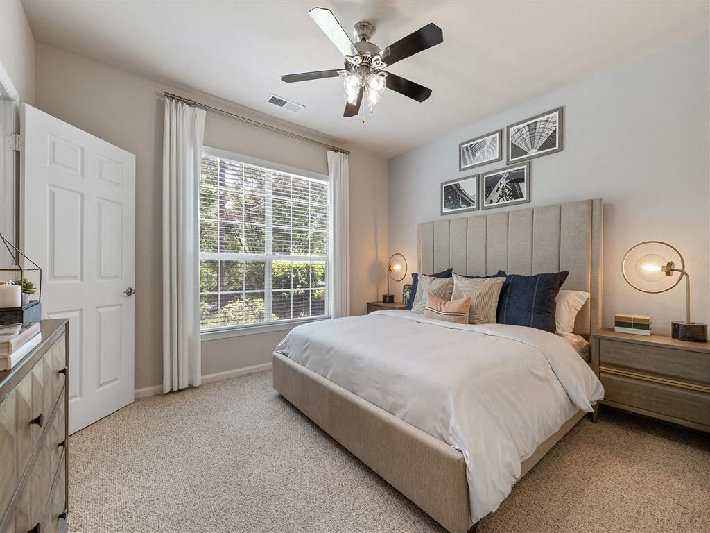 a bedroom with a bed and a ceiling fan
