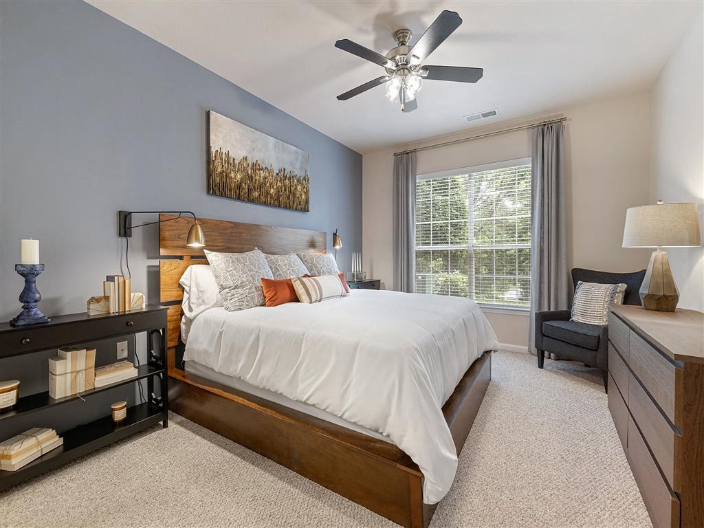 a bedroom with a bed and a ceiling fan