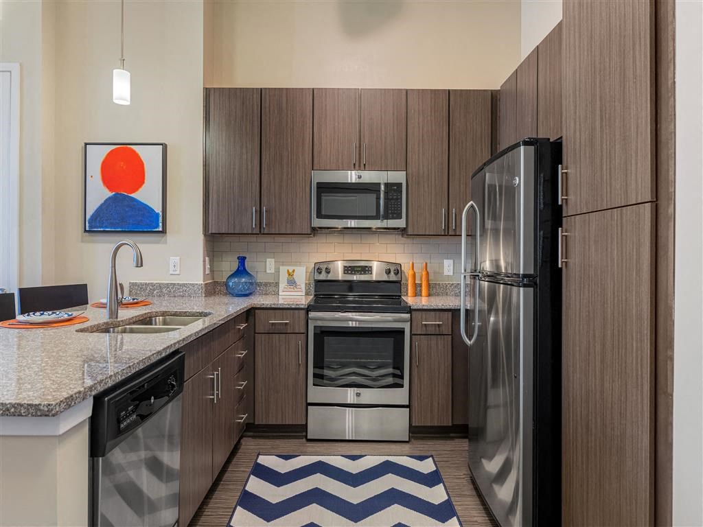 a kitchen with stainless steel appliances and wooden cabinets
