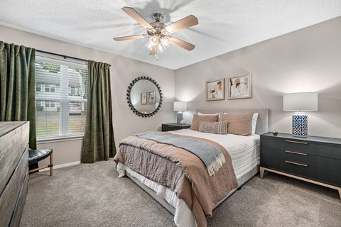 a bedroom with a bed and a ceiling fan