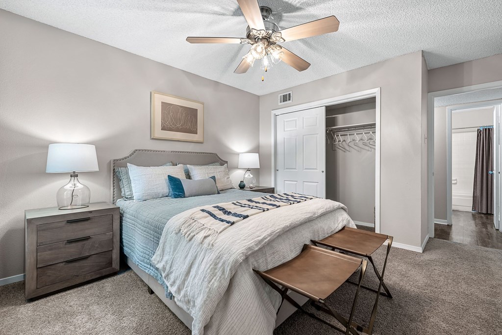 a bedroom with a bed and a ceiling fan