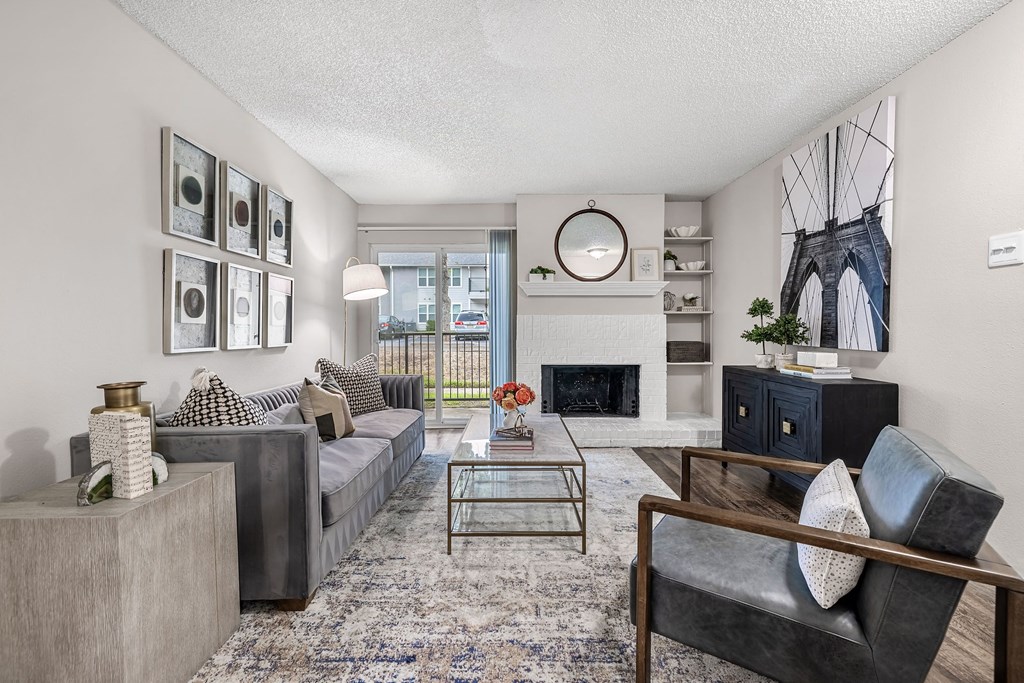 an open living room with couches and a fireplace