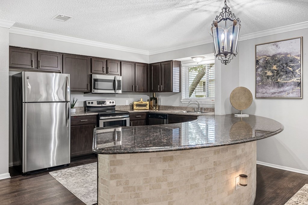 a kitchen with stainless steel appliances and a counter top