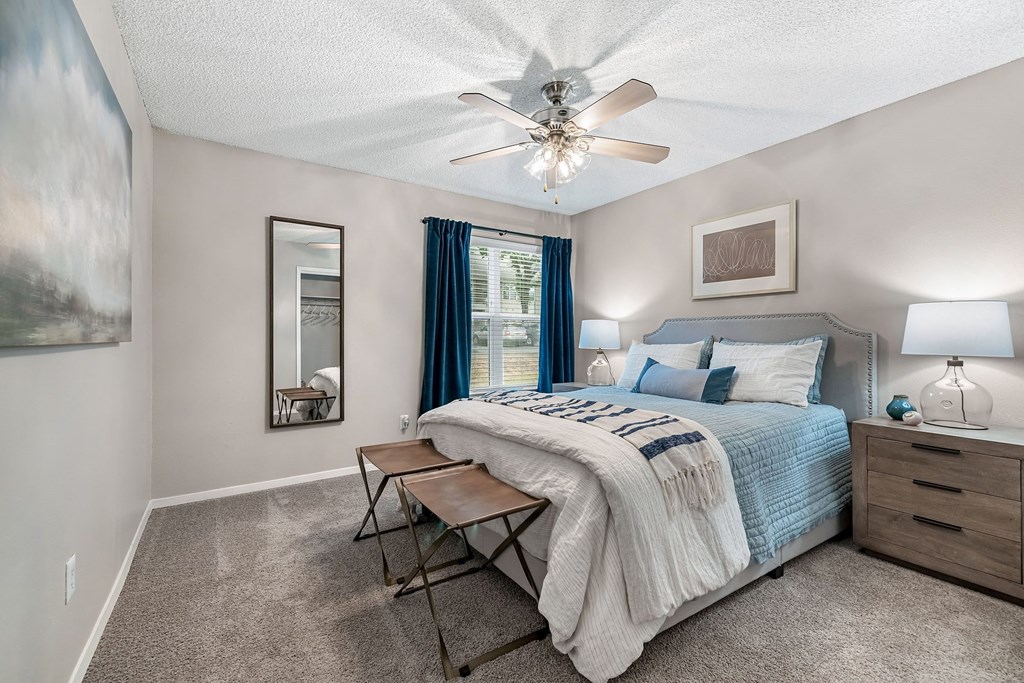 a bedroom with a bed and a ceiling fan