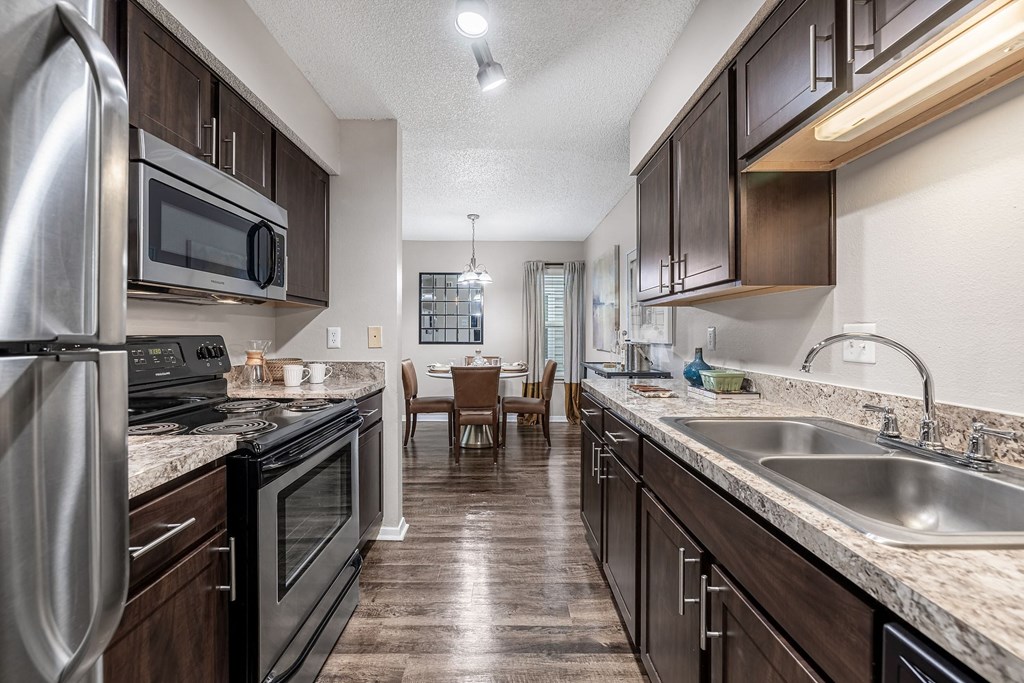 a kitchen with stainless steel appliances and granite counter tops