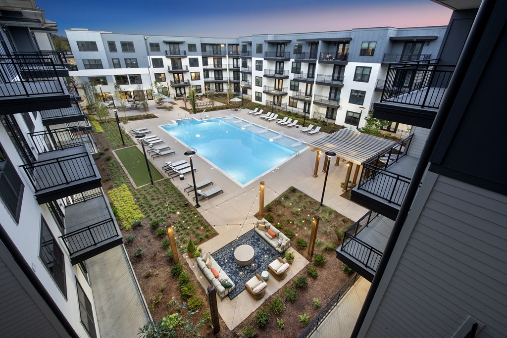 an overhead view of an apartment building with a swimming pool