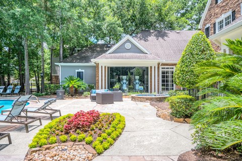 A house with a pool and a garden in front.