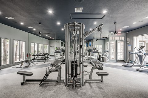 A well-equipped gym with a variety of machines and weightlifting equipment.