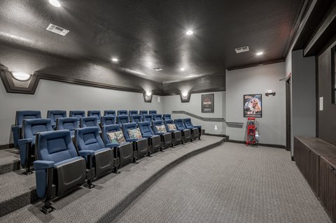 A row of blue chairs are lined up in a room.