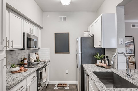 A kitchen with a blackboard on the wall.