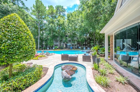 A small pool with a rock in the middle of it.