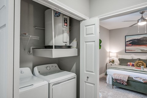 A small laundry room with a washer and dryer.