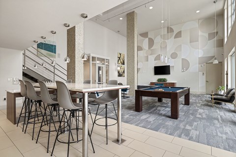 A modern dining room with a glass table and chairs.