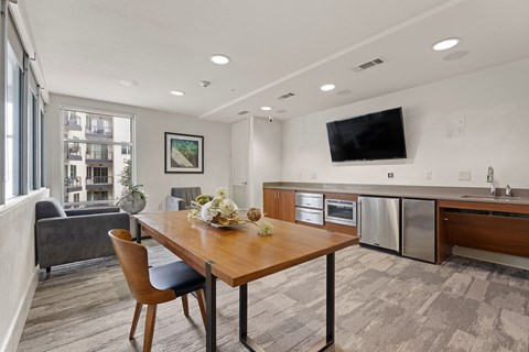A modern kitchen with a dining table and chairs.