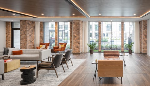 A living room with a white couch and a wooden coffee table.