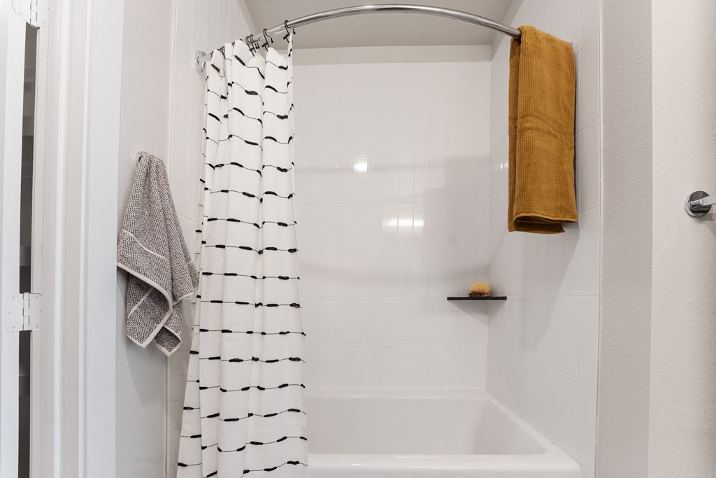 a small bathroom with a shower and a shower curtain