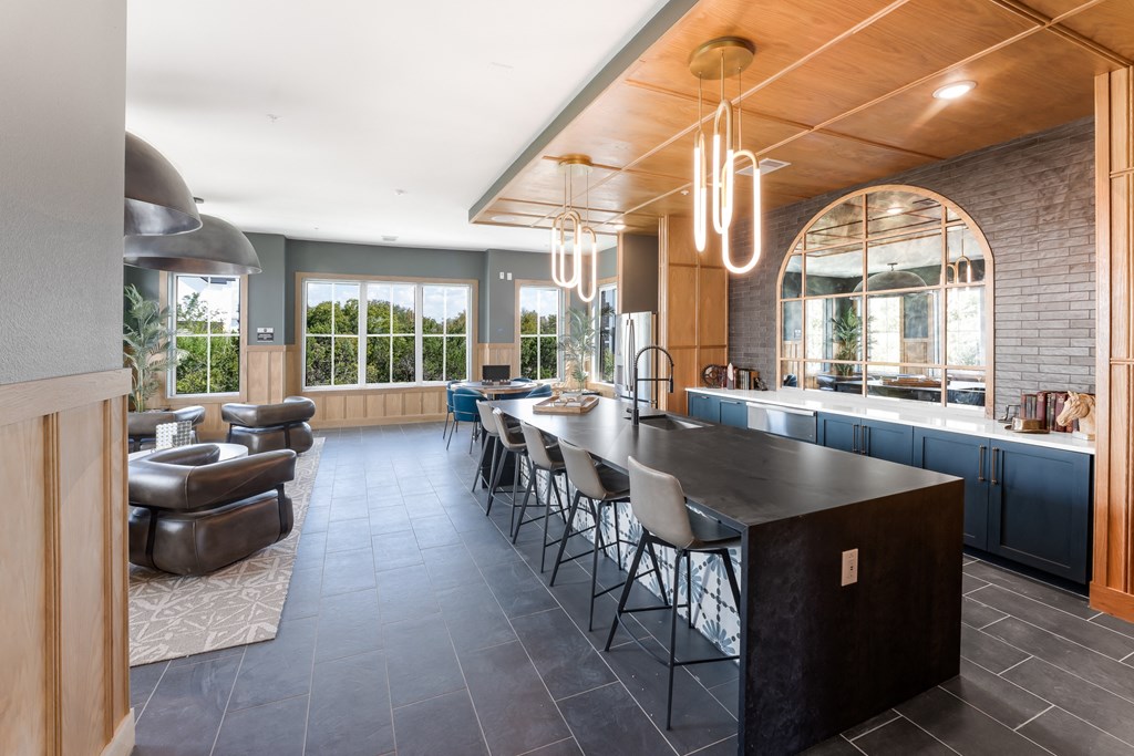 the kitchen and dining area of a house with a large island and chairs