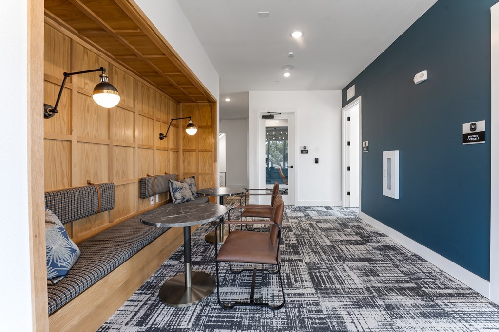 a living room with a table and chairs and a couch