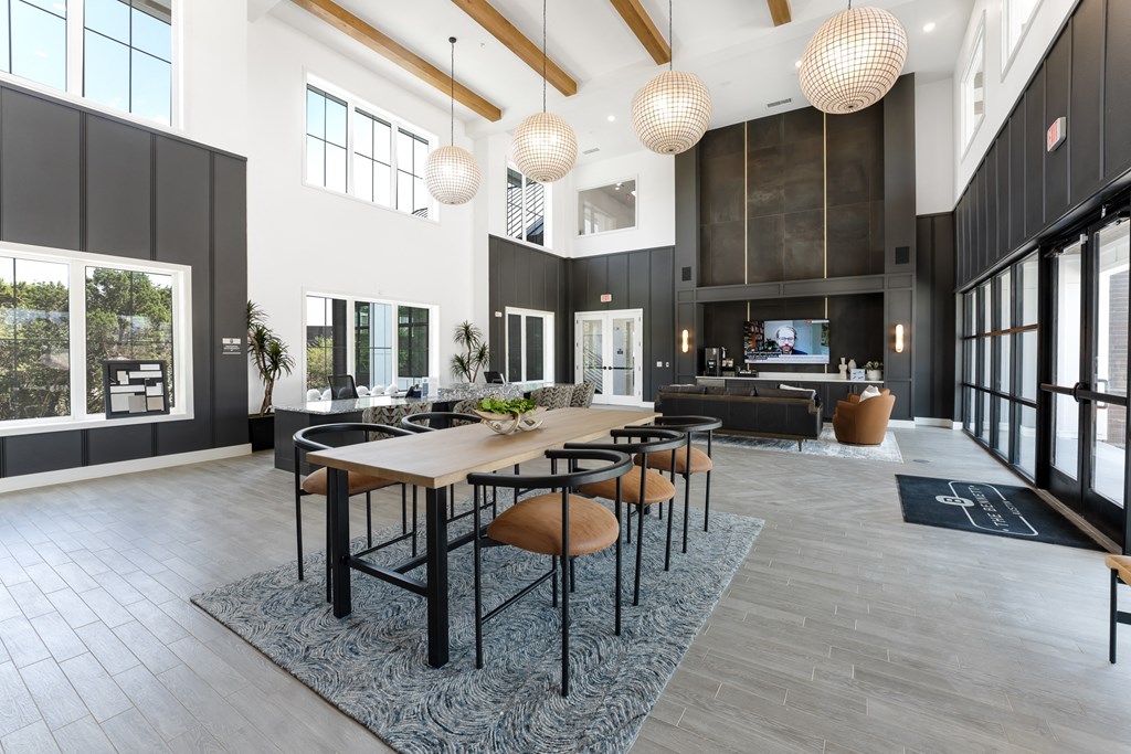 a large living room with a long table and chairs