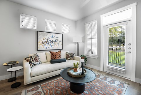luxury living room with natural lighting, coffee table, and couch
