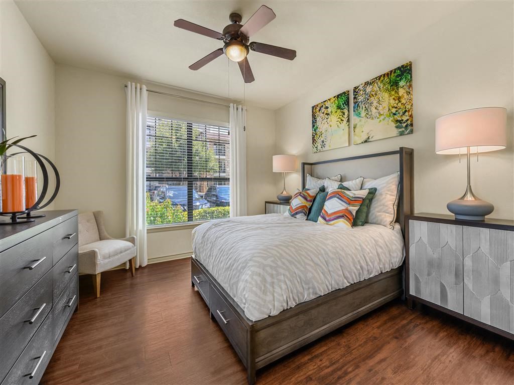 a bedroom with a bed and a ceiling fan