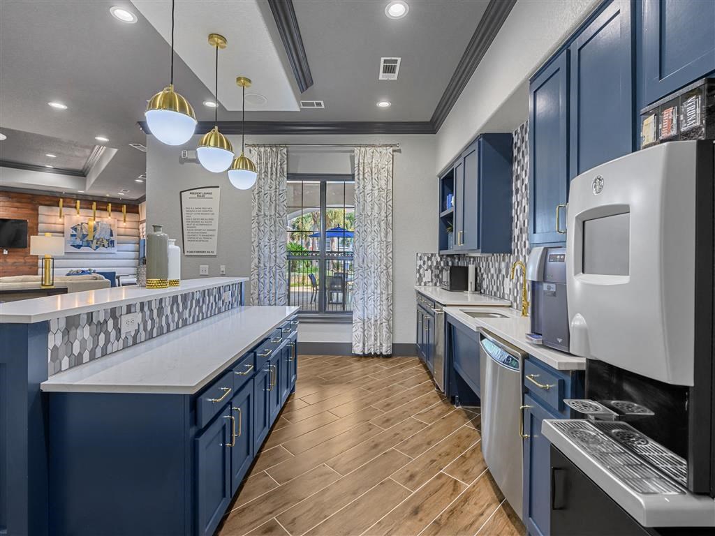 a kitchen with blue cabinets and counter tops