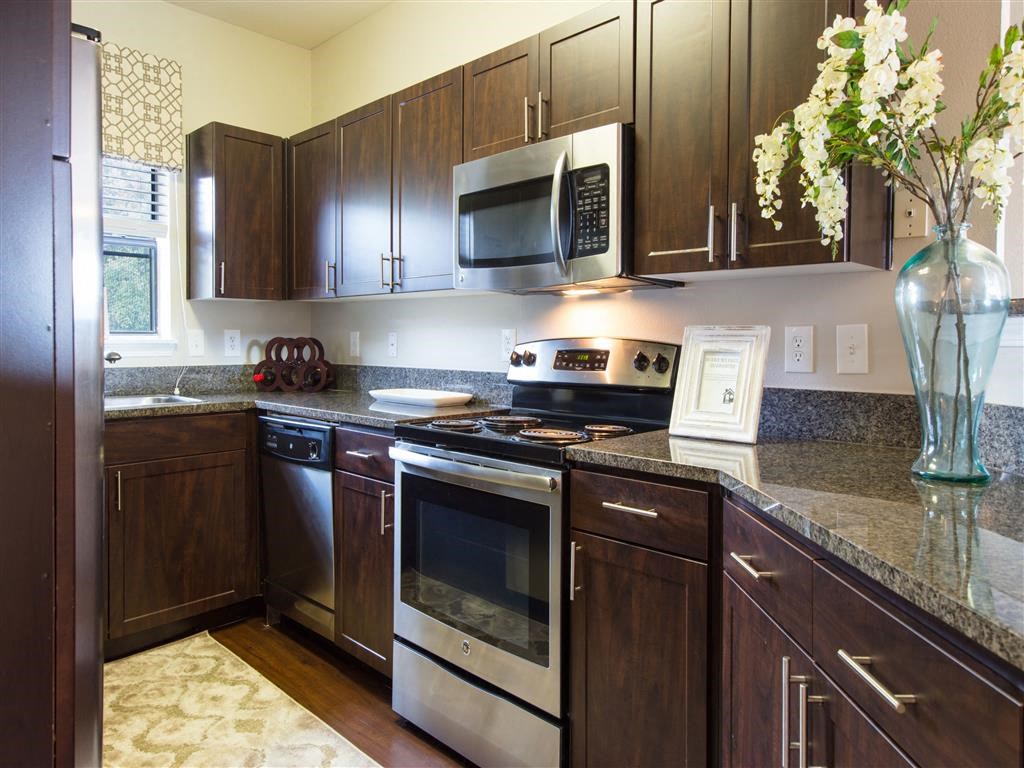 a kitchen with stainless steel appliances and granite counter tops