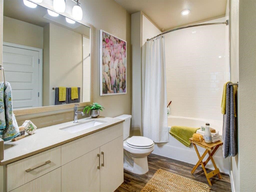 a bathroom with a toilet and a shower and a sink