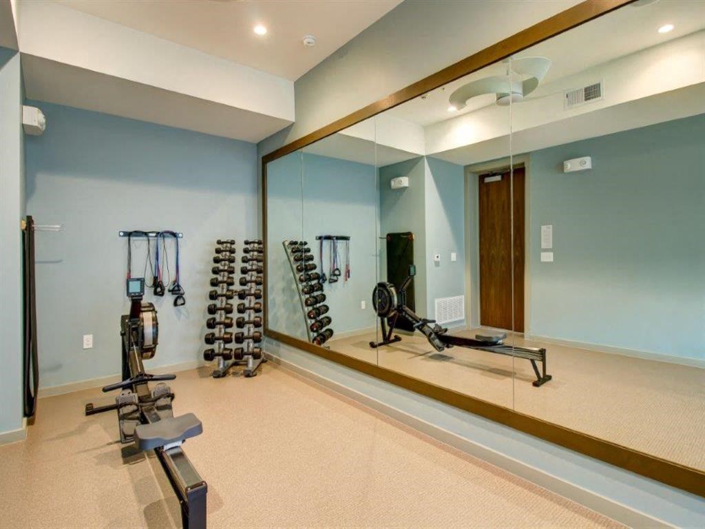 a mirror in a home gym with weights and dumbbells