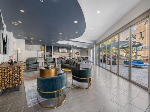 A modern living room with a curved ceiling and a large glass door.