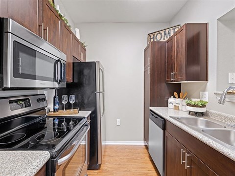A kitchen with a black refrigerator and stove.