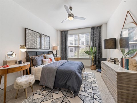 a bedroom with a bed and a ceiling fan