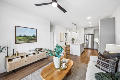 A modern living room with a wooden coffee table and a painting on the wall.