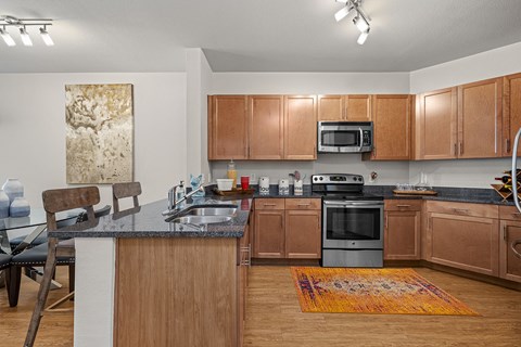 full kitchen with granite counter tops and stainless steel appliances